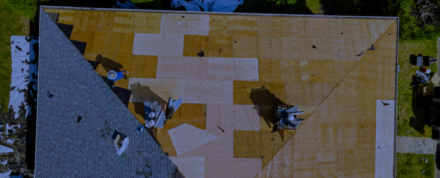 workers replaicing and repairing a roof of a house
